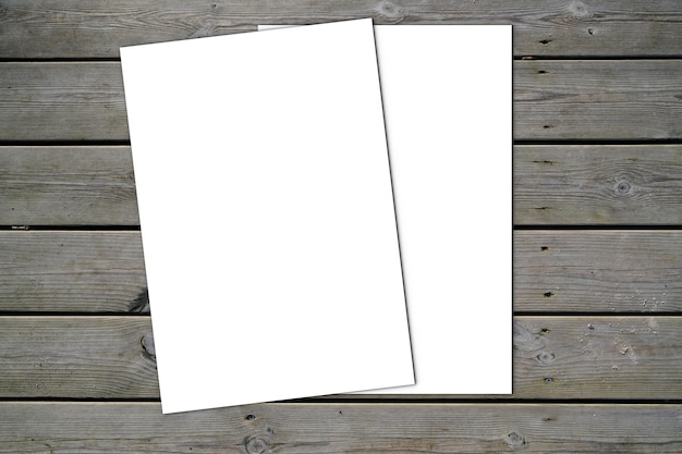 Photo mockup blank two white paper and space for text on old wooden plank background