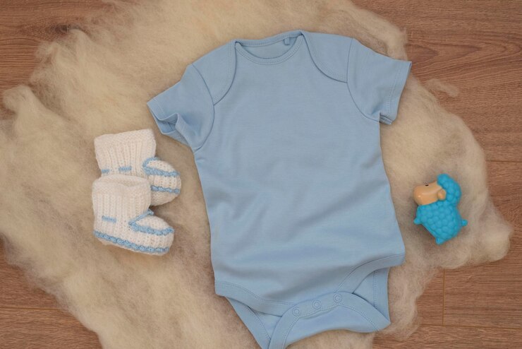 Mockup of blue baby bodysuit on wood background Blank baby clothes template mock up