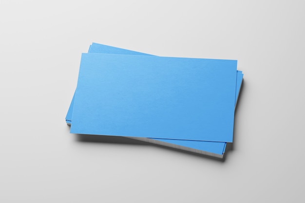 Mockup of blue business cards stack at white textured paper background