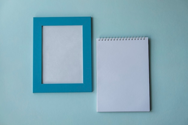 Mockup, blue frame and notepad on a blue background, postcard