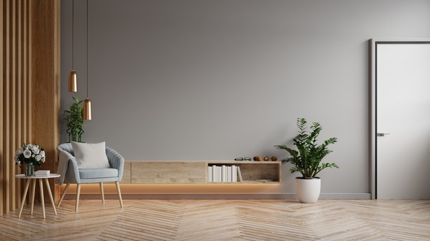 Mockup cabinet in modern living room with blue armchair and plant on dark gray wall background,3d rendering