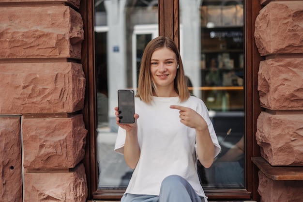 Mockup caucasian woman shows finger at phone