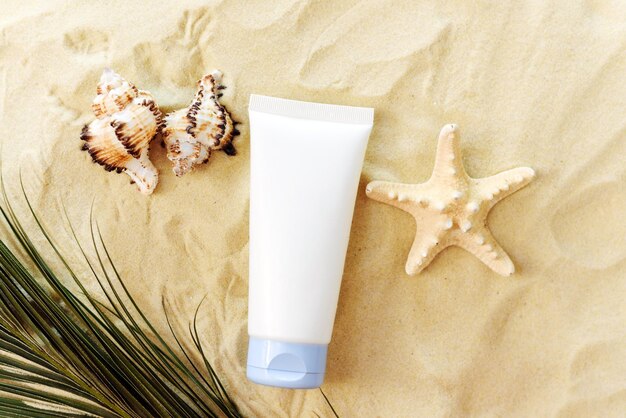 Mockup of a cream in a tube a moisturizing cosmetic product in a plastic package on a beach background with sand Product presentation on a sandy background Top view Mockup