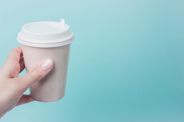 Mockup of female hand holding a Coffee paper cup isolated 
