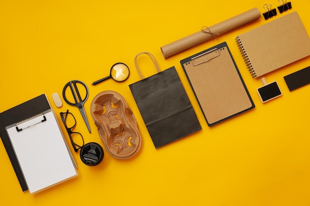 Mockup flat lay with different office accessories on yellow background