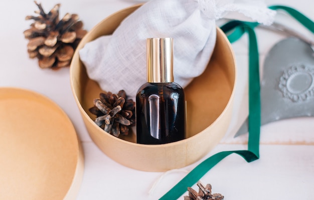 A mockup of a glass bottle with a cosmetic product as a christmas present