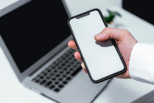 mockup image of a hand holding mobile phone with blank screen