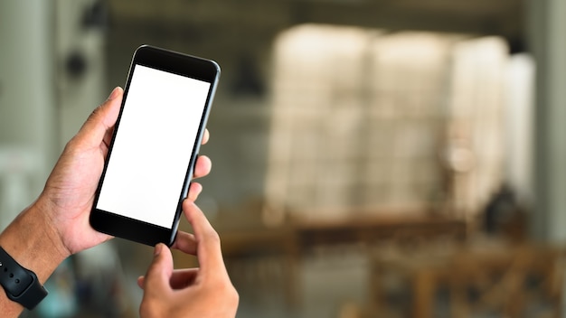 Mockup image of hands holding  smart phone with blank white screen