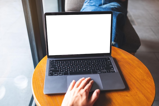 Mockup image of a man using and touching on laptop touchpad with blank white desktop screen