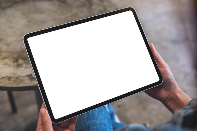 Mockup image of a woman holding digital tablet with blank white desktop screen