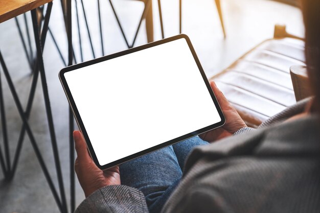 Mockup image of a woman holding digital tablet with blank white desktop screen