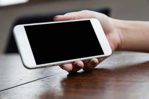 Mockup image of a woman holding a phone