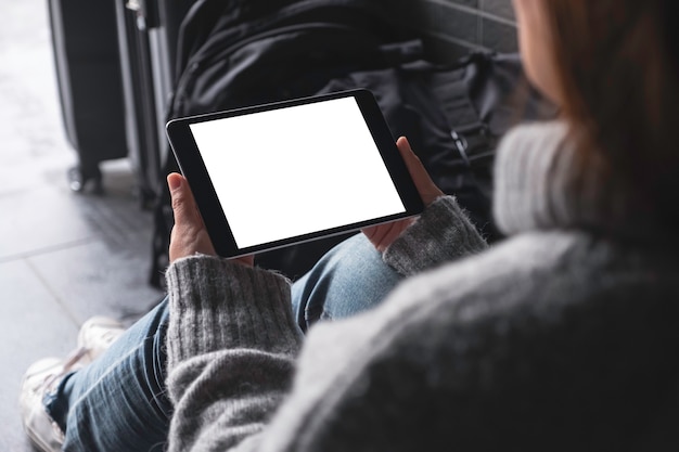 Mockup image of woman's hands holding and using black tablet pc