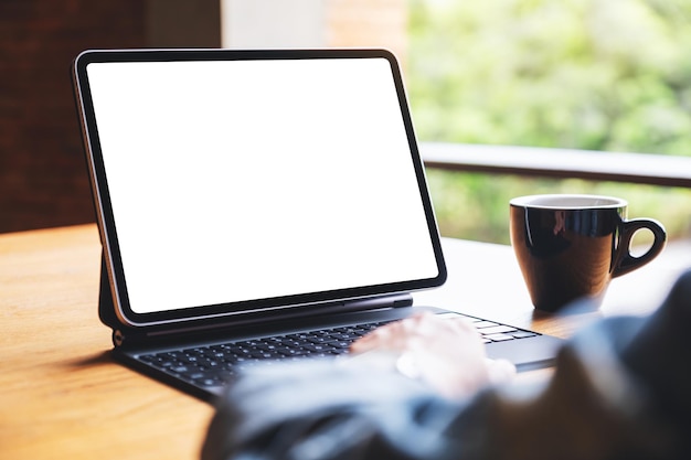 Mockup image of a woman touching on tablet touchpad with blank white desktop screen as computer pc