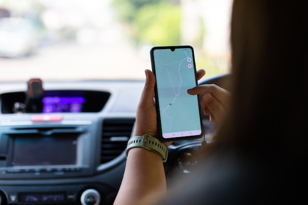 mockup image of a woman using smartphone with blank screen. beautiful fat woman driving a car