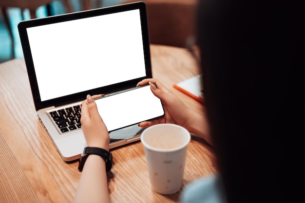 Mockup image of woman working in cafe with laptop