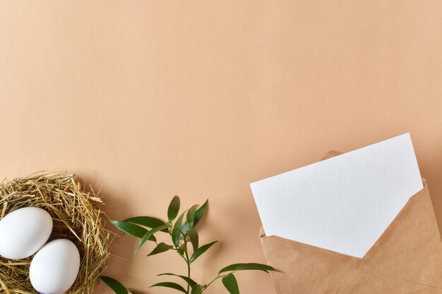 A mockup of a kraft envelope with a white sheet of paper eggs and a packed gift