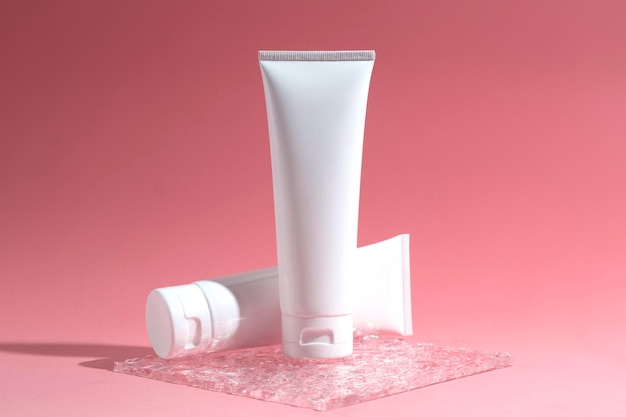 Mockup of medical skin care bottle cosmetic tube of beauty makeup facial treatment cleanser face foam beauty healthcare branding packaging in water splash