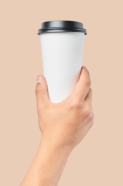 Mockup of men's hand holding white paper large size cup with black cover