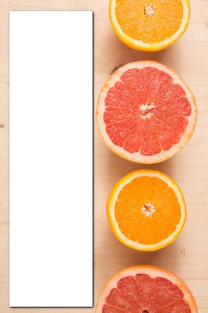 Mockup orange grapefruit cut slice on wooden background for menu top view and blank card paper empty invitation recipe space for text concept of vitamin good healthy food