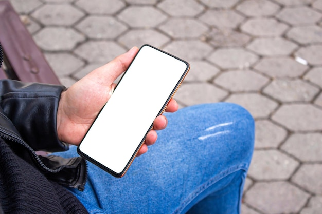 Mockup phone. Hand holding smartphone at the outdoor.