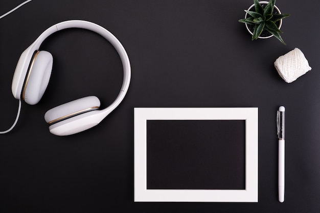 Mockup, Photo Frame, Headphones, Pen, and Cactus Write object on Black background