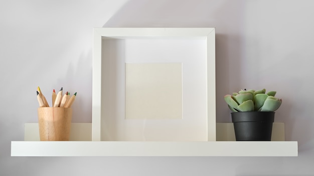 Mockup poster with plant on white shelf