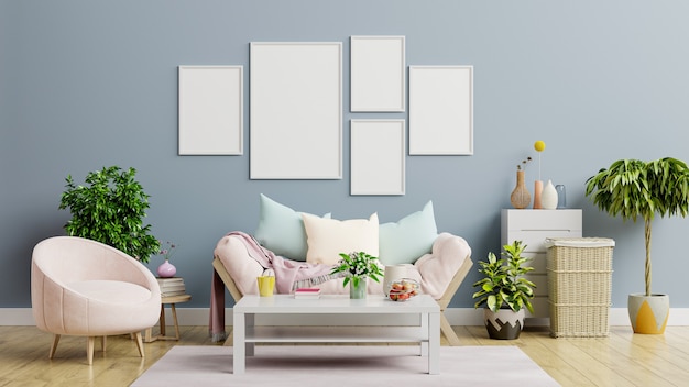 Mockup of a poster with vertical frames on an empty dark blue wall in a living room with a sofa and an armchair.3D rendering