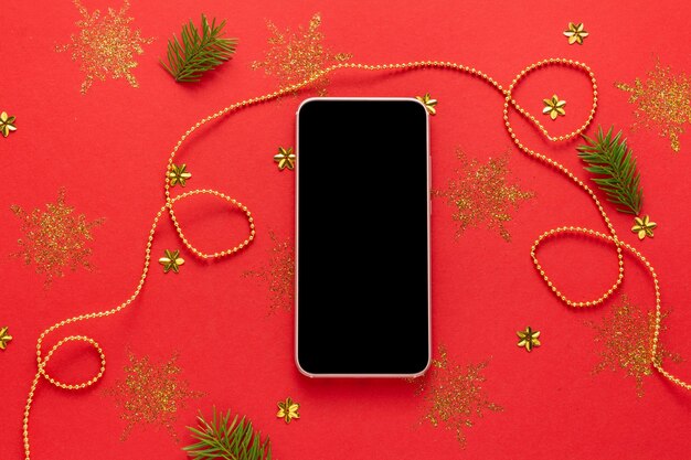 Photo mockup of smartphone with black screen on decorated red christmas background