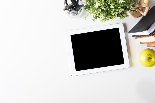 Photo mockup tablet digital on workspace with top view table.