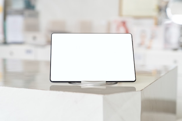 Photo mockup tablet with blank white screen on table.