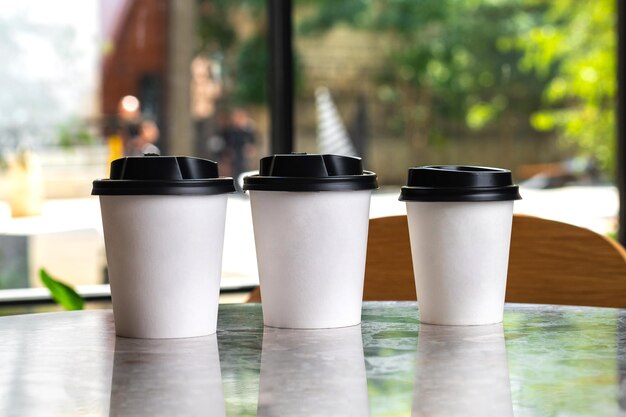 Mockup take away coffee cup empty blank copy space for design paper cups of coffee on gray stone table background