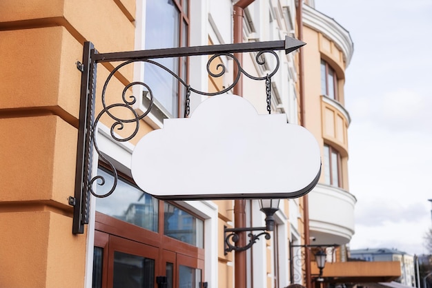 Photo mockup for title logo white sign in the form of a cloud on an old building