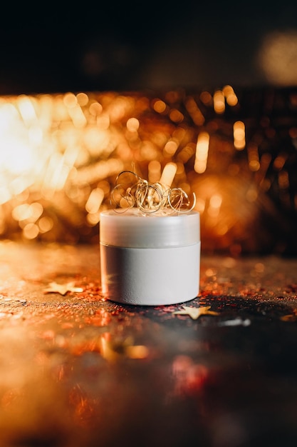 mockup of a tube of cream on a festive shining background, night cream for skin