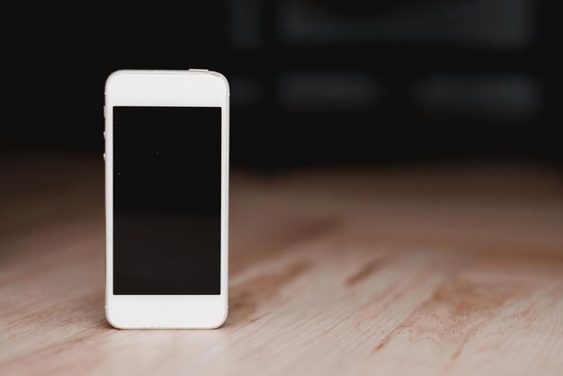 Mockup of the vintage phone with a sensor display on the wooden floor Backside view of the phone