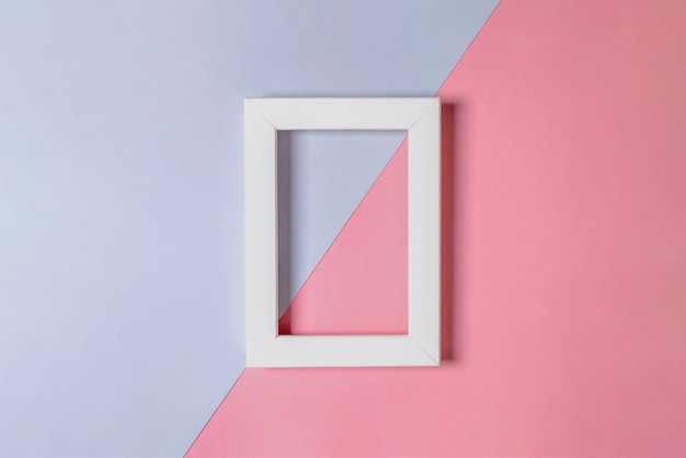 mockup of a white blank frame on a pink and lilac layer. minimalism. selective focus.