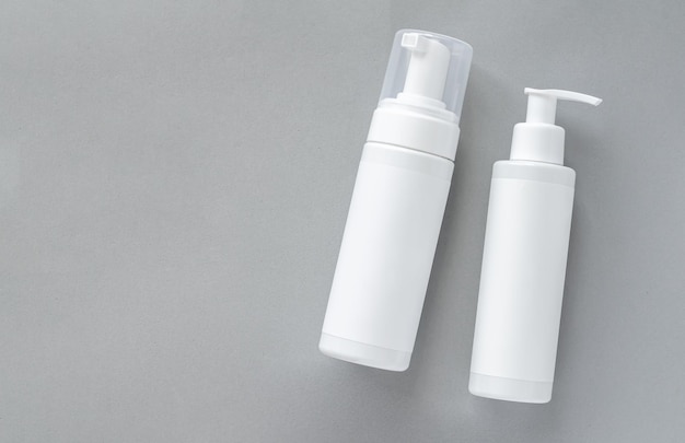 Mockup of white plastic cosmetics bottles with skincare