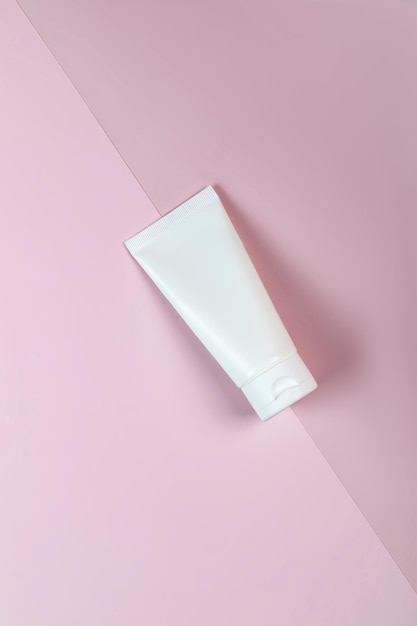 Mockup of white squeeze bottle plastic tube for branding of medicine or cosmetics cream gel skin care toothpaste Cosmetic bottle container on a pink background Minimalism