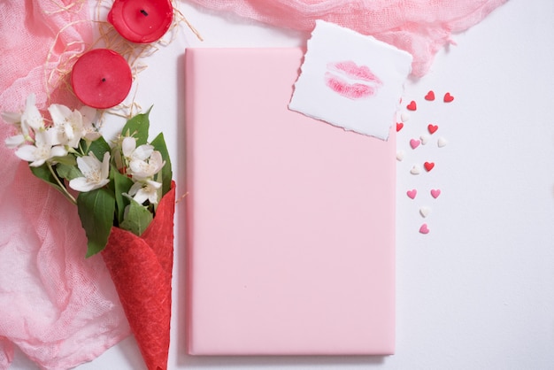 Mockup with postcard and jasmine on pink background. card and white flowers.waffle for ice cream, lip kiss