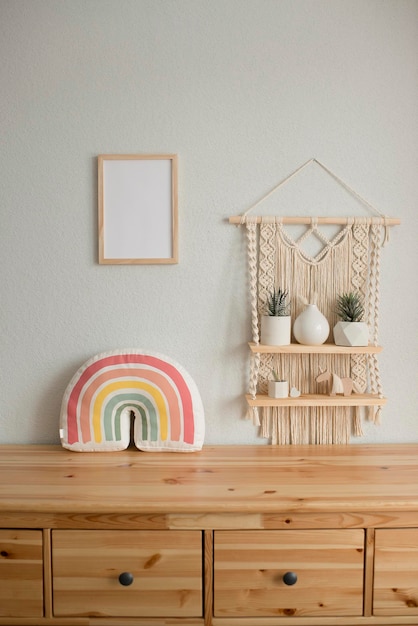 Photo mockup wooden frame in the interior of the room, macrame shelf and wooden chest of drawers