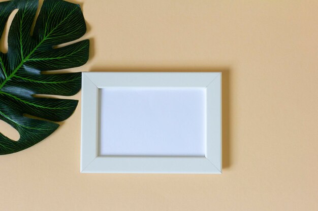 A mockup of a wooden frame for a photo or a picture on a table with a copy of the space