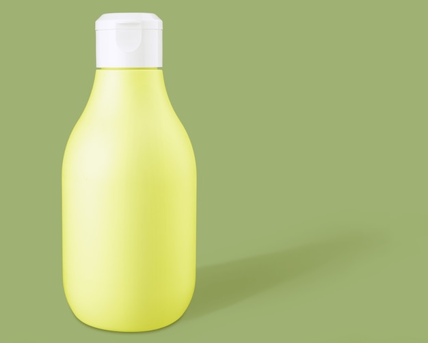 Mockup yellow biodegradable plastic cosmetic bottle on a green background. Front view and copy space