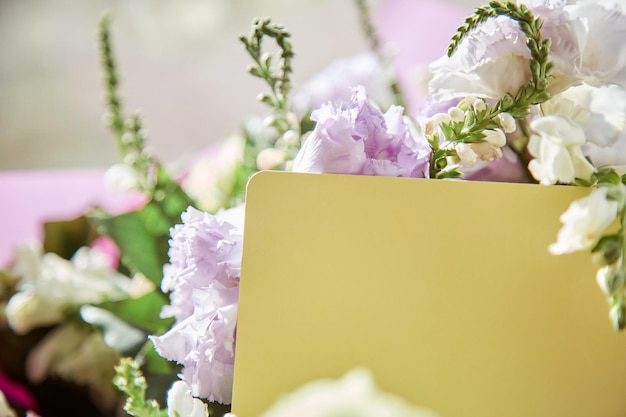 Mockup of yellow post card close up with delicate big flowers bouquet of eustoma Copy space Flowers delivery and present concept High quality photo