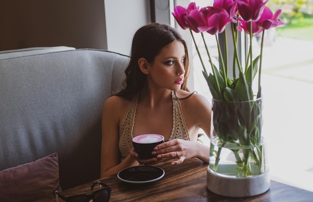 Mode meisje geniet van koffie in coffeeshop. cappuccino americano latte-espresso.