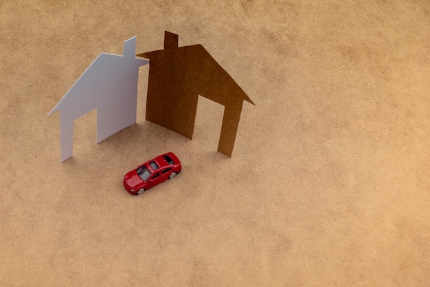 Model car and house shape cut out of paper