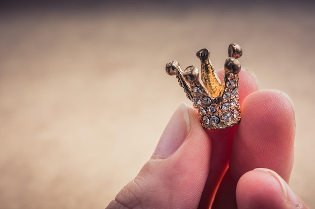 Model crown with pearls in hand