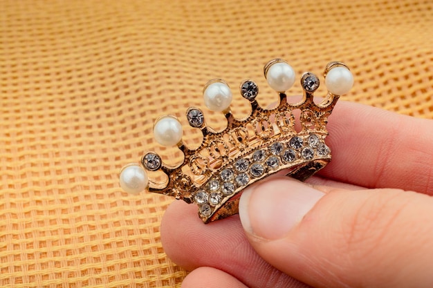 Model crown with pearls in hand