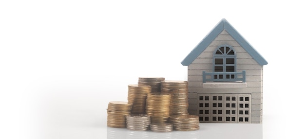 Model of detached miniature house mock up on coins. property real estate investment concept