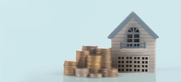 Model of detached miniature house mock up on coins. property real estate investment concept