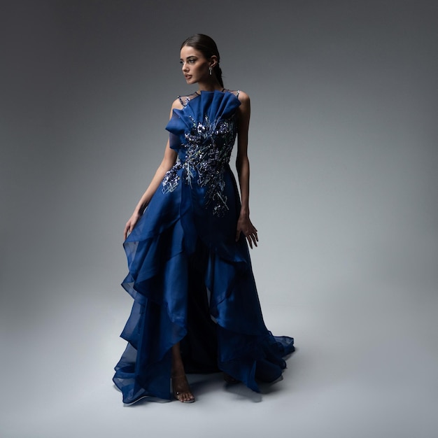 A model in an elegant evening dress dress